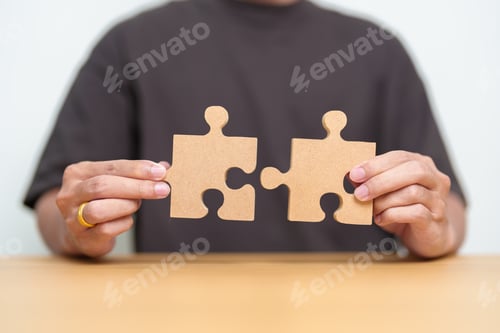 Preview: Hand connecting couple puzzle piece.