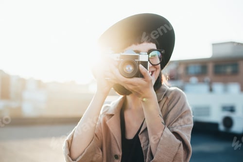 Preview: Hipster millennial woman at rooftop at sunset