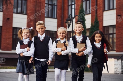 Preview: Group of kids in school uniform that is outdoors together near education building