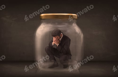 Preview: Businessman Shut Into A Glass Jar Concept On Background