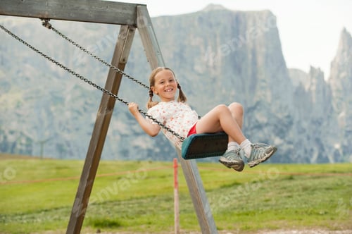Preview: Italy, Seiseralm, Girl (6-7) sitting on swing, portrait