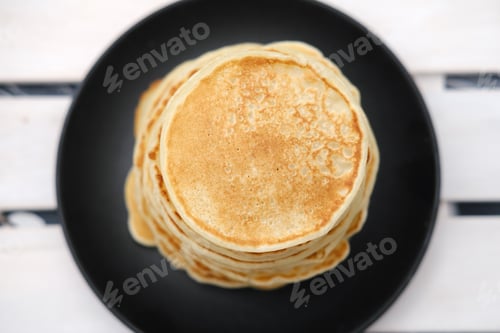Preview: stack of classic american pancakes on a wooden rack.