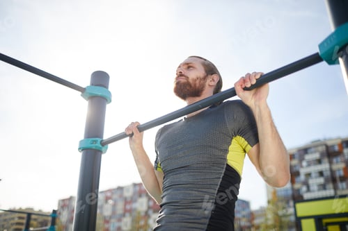 Preview: Bearded guy hanging on outdoor bar