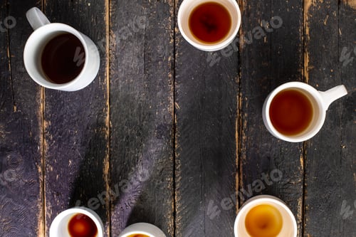 Preview: White cups with coffee residue on wooden table with space for text