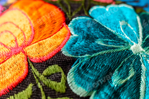 Preview: Background of hand-embroidered flowers on a fabric with colored threads.