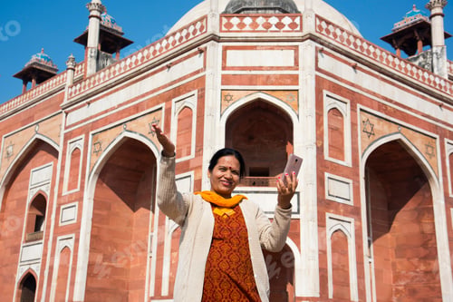 Preview: Indian woman taking selfie with smartphone in front of Humayun's Tomb