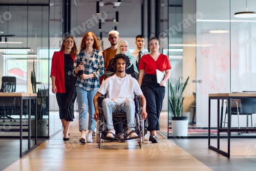 Preview: A diverse group of young business people walking a corridor in the glass-enclosed office of a modern