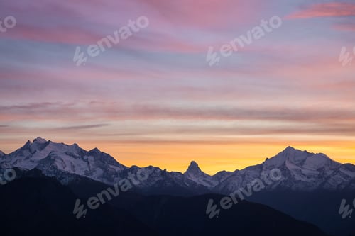 Preview: Landscape view of a soft sunset over a mountain range in Switzerland with the Matterhorn