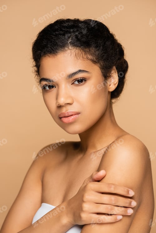 Preview: young african american woman with bare shoulders isolated on beige