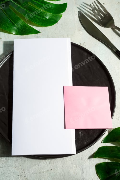 Preview: Paper brochure on a ceramic plate with fork and knife