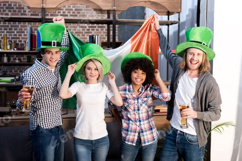 Preview: multiethnic friends celebrating saint patrick day at home