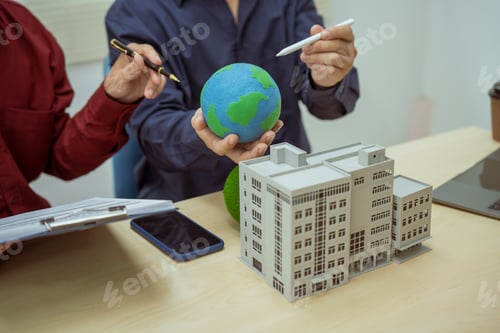 Preview: Two businessmen work at desks office,discussing city clean energy strategies global technology