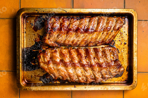 Preview: Barbecue grilled pork spare ribs. Orange background. Top view