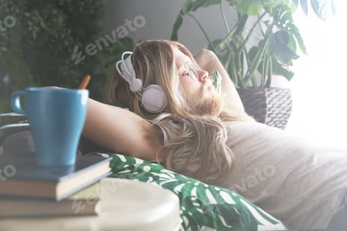 Preview: Adult Listening to Music Lying on a Couch