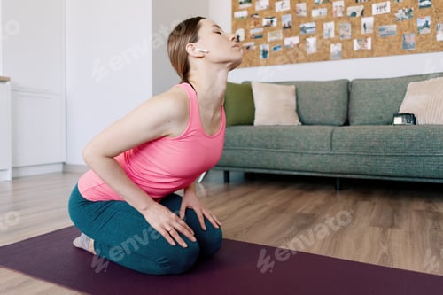 Preview: Caucasian woman practicing yoga at home