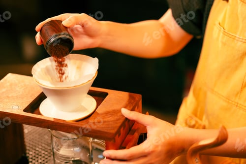 Preview: Pouring Coffee Grounds into a Filter