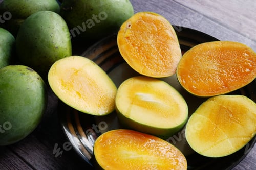 Preview: yellow ripe cut mango in a bowl top down