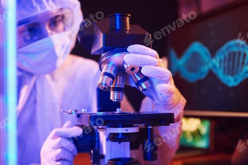 Preview: Nurse in mask and white uniform sitting in neon lighted laboratory