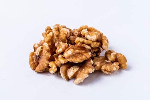 Preview: Peeled walnuts on white background.