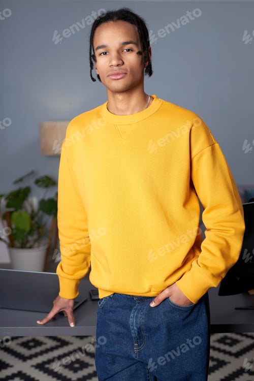 Preview: Young black man wearing bright yellow hoodie