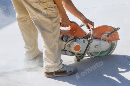 Preview: This is construction worker cutting concrete for sidewalks using an diamond bladed saw cut off.