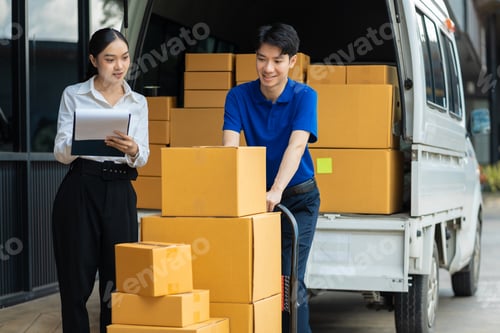 Preview: Asian delivery man deliver box parcel package to customer at home