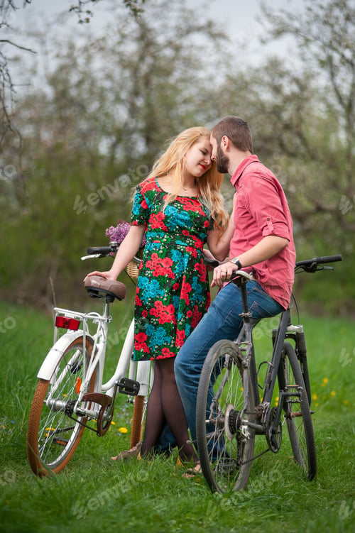 Preview: Loving young couple with bicycles