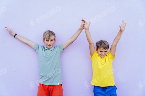 Preview: Two school boys friends in colorful outfits against purple wall