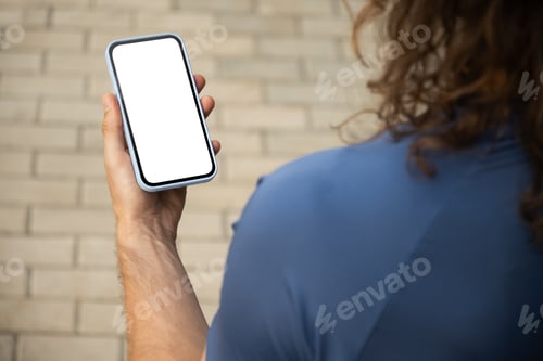 Preview: Man using mobile phone at modern city. Outdoors.