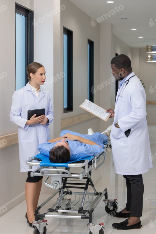 Preview: Two Doctors Discussing Patients' Medical History in Hospital Corridor