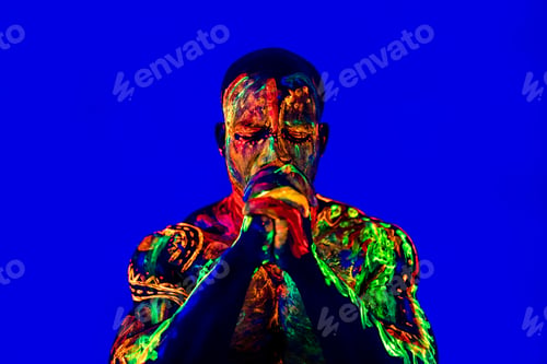 Preview: afro american man with UV body art posing in studio