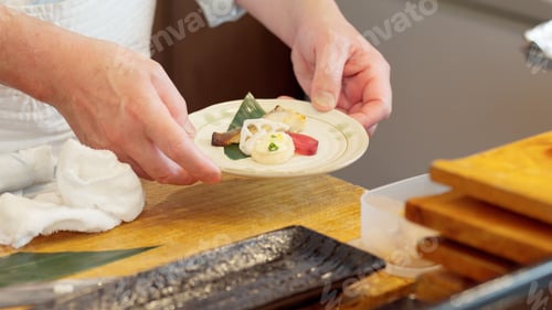 Preview: Chef's hands arranging food on a plate