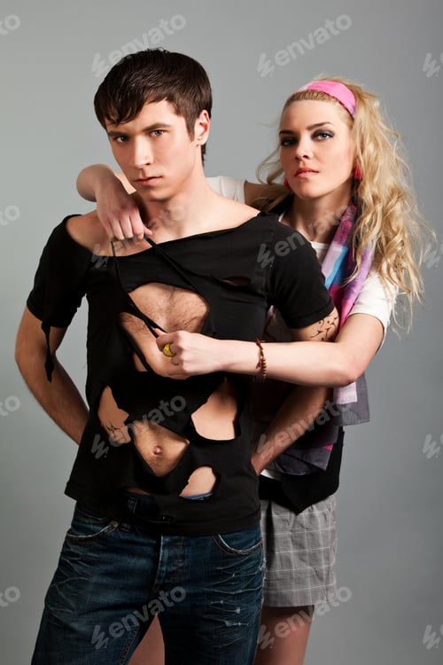 Preview: Young woman in pink clothing embracing young man in black