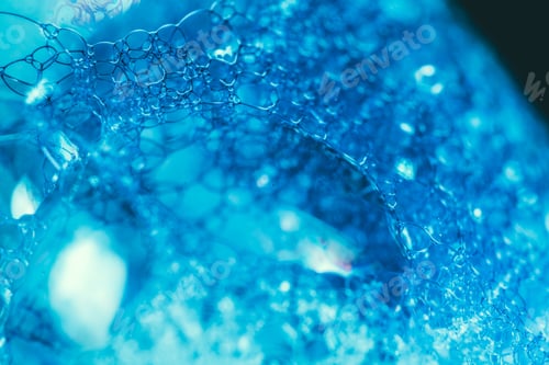 Preview: Closeup of blue translucent soap bubbles floating on the water surface, perfect for backgrounds