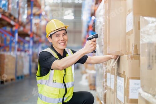 Preview: Staff working in large depot storage warehouse hold wireless barcode scanner scan box at shelf