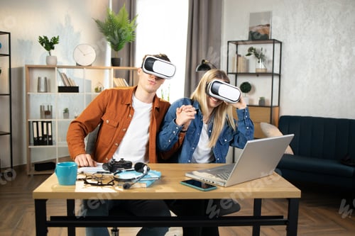 Preview: Excited family using VR glasses for playing games at home