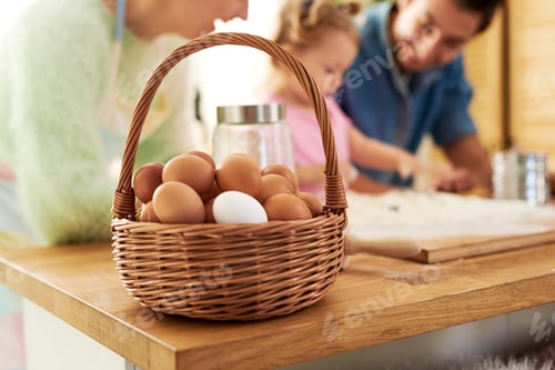 Preview: A full basket of eggs and family in the background
