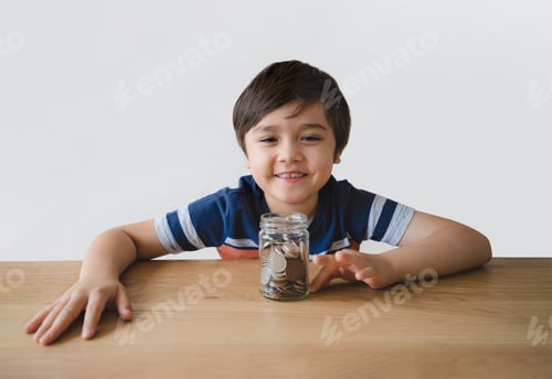 Preview: Smiling Child with Jar of Coins at Table