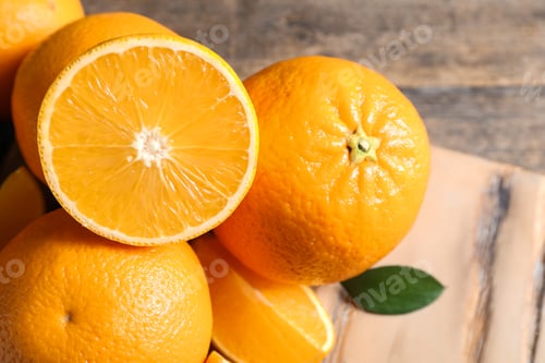 Preview: Fresh oranges with leaves on wooden table, closeup