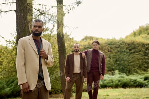 Preview: Stylish men embrace autumn in a vibrant field, showcasing fashion against nature's backdrop