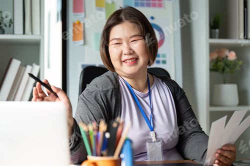 Preview: Smiling graphic designer presenting design ideas in a creative workspace