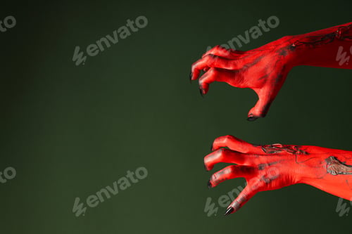 Preview: Creepy, red hands of a monster with black nails