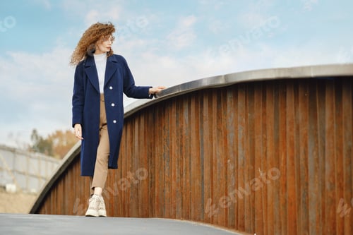 Preview: Young woman on rusty bridge