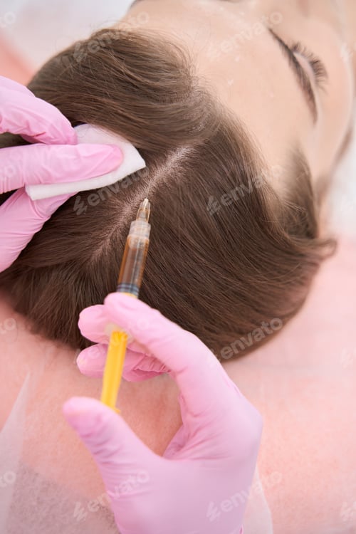 Preview: Syringe is injected subcutaneously on the skin of a head