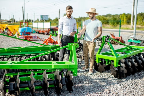 Preview: Agronomist with salesman at the shop with agricultural machinery