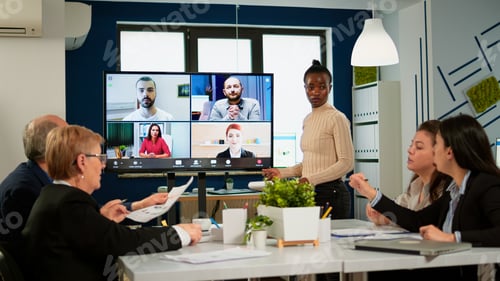 Preview: Black manager woman talking with remotely colleagues on video call