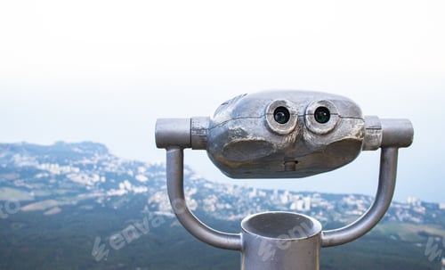 Preview: Binoculars on the top of the mountain with a view of the city and the sea