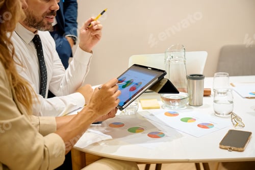 Preview: Business colleagues analyzing data during a team meeting