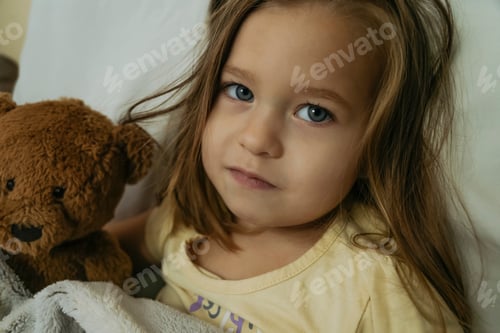 Preview: Portrait of sad sick little girl looking to the camera