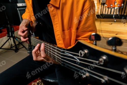 Preview: rock performer with electric guitar in recording studio recording playing track